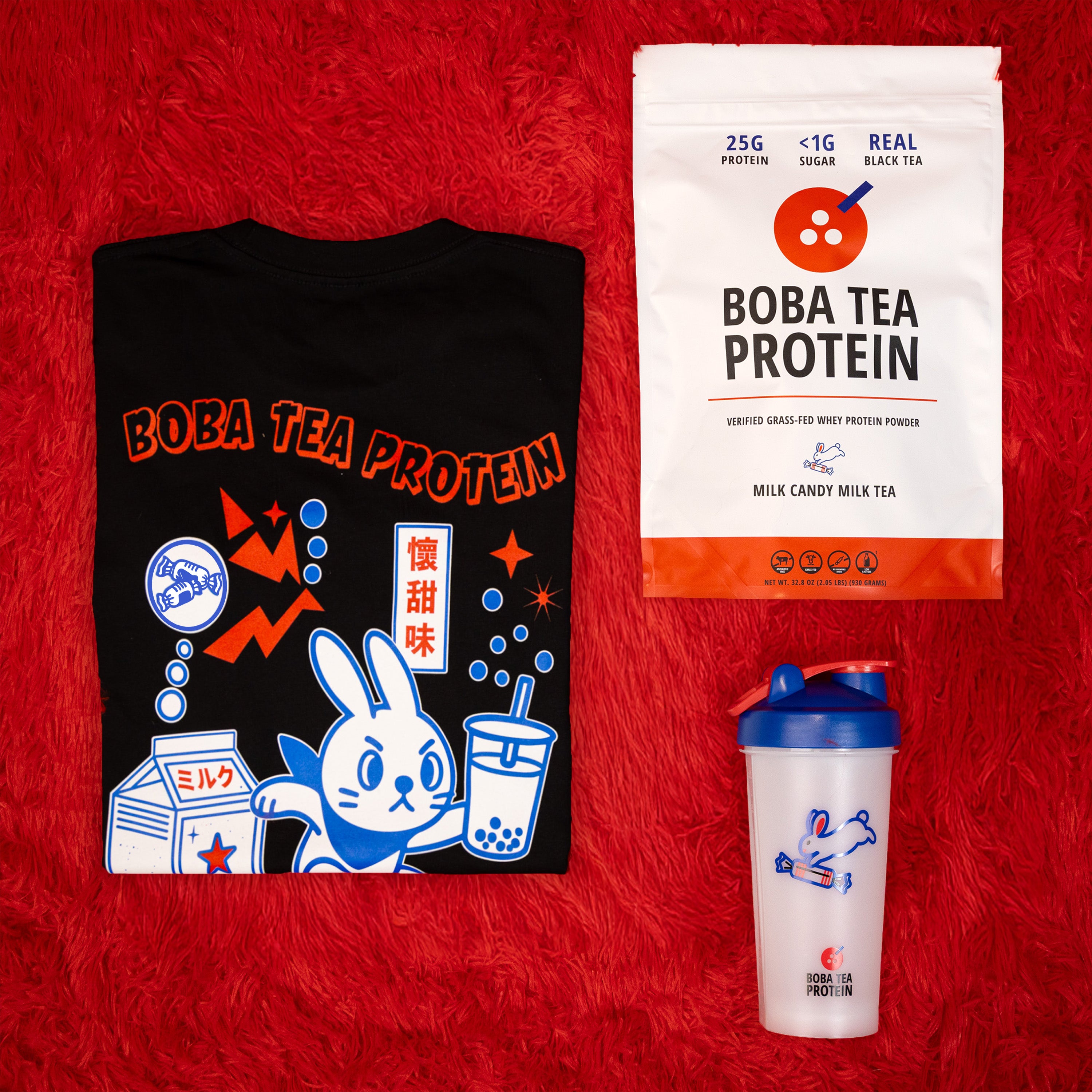 Black t-shirt, Boba Tea Protein package, and white cup with blue lid on a red background
