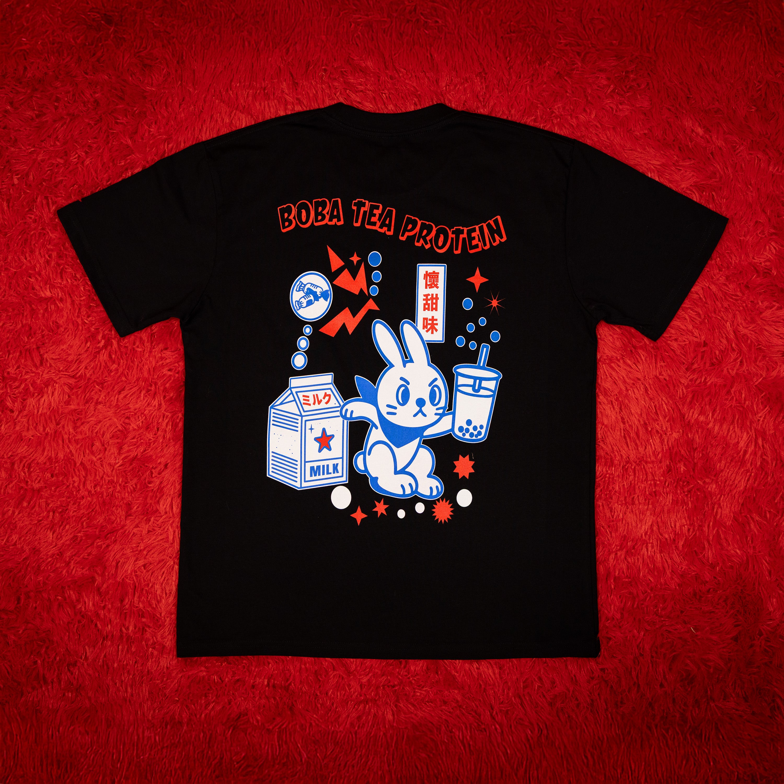 Black t-shirt with a rabbit cartoon character and text on a red background