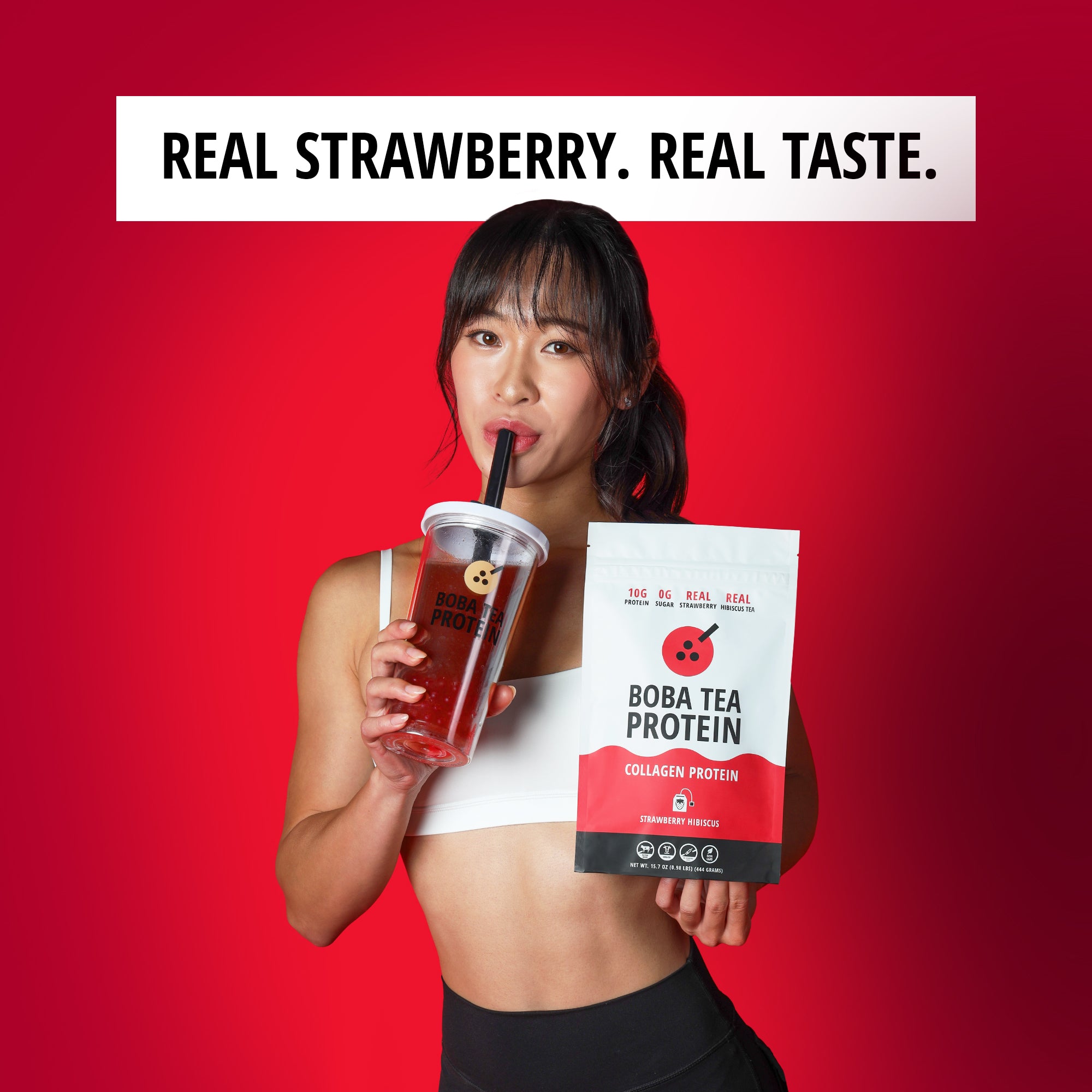 Woman holding a Boba Tea Protein package and a drink against a red background