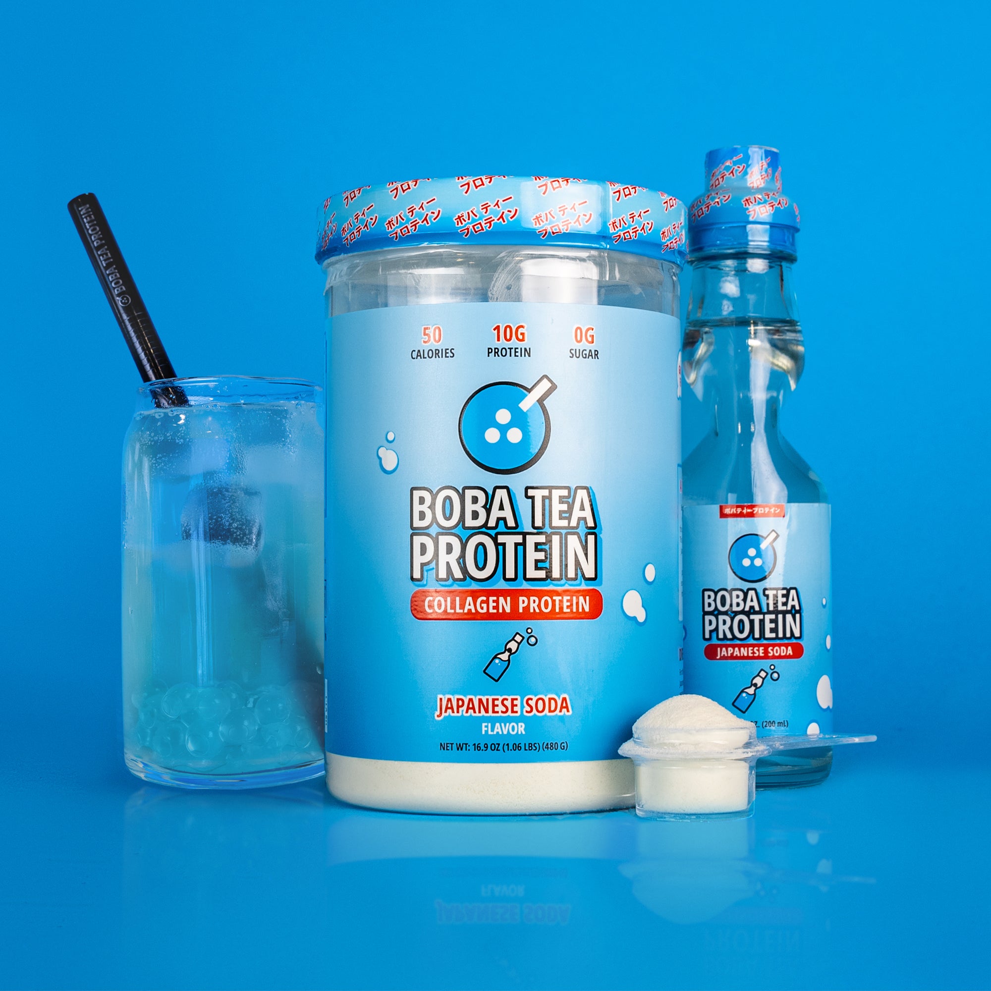 A container of "Boba Tea Protein Collagen Protein" in Japanese soda flavor is displayed, with blue packaging showing nutritional details like "50 calories," "10g protein," and "0g sugar." Next to it are a matching glass bottle, a glass of the prepared drink with ice and a black straw, and a small clear scoop of white powder, all set against a vibrant blue background.