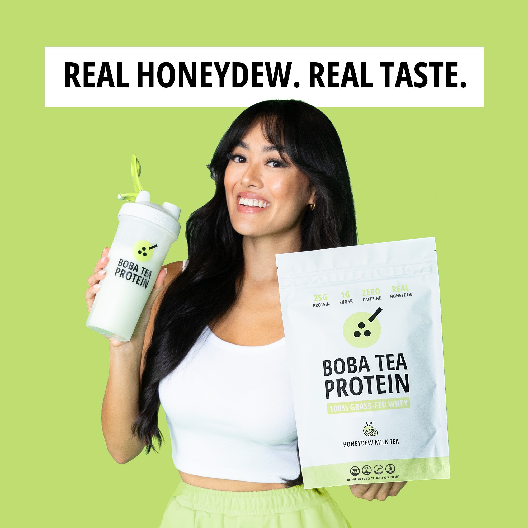 Woman holding Boba Tea Protein packaging and a white tumbler with green straw on a green background, with text that says "Real Honeydew. Real Taste."