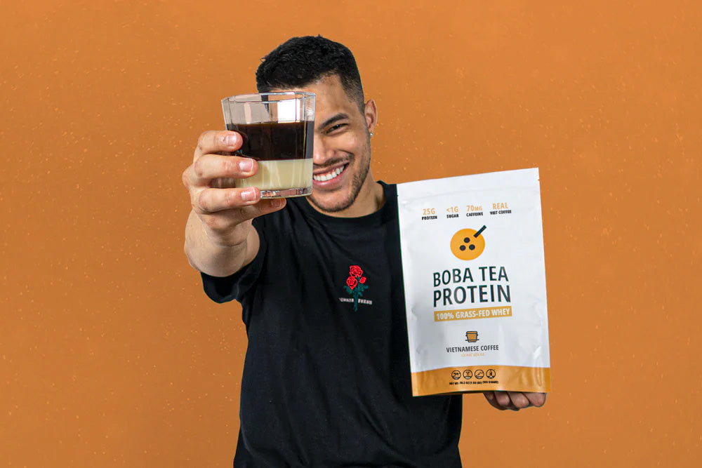 Man holding a cup of Vietnamese Coffee and a bag of Boba Tea Protein's Vietnamese Coffee