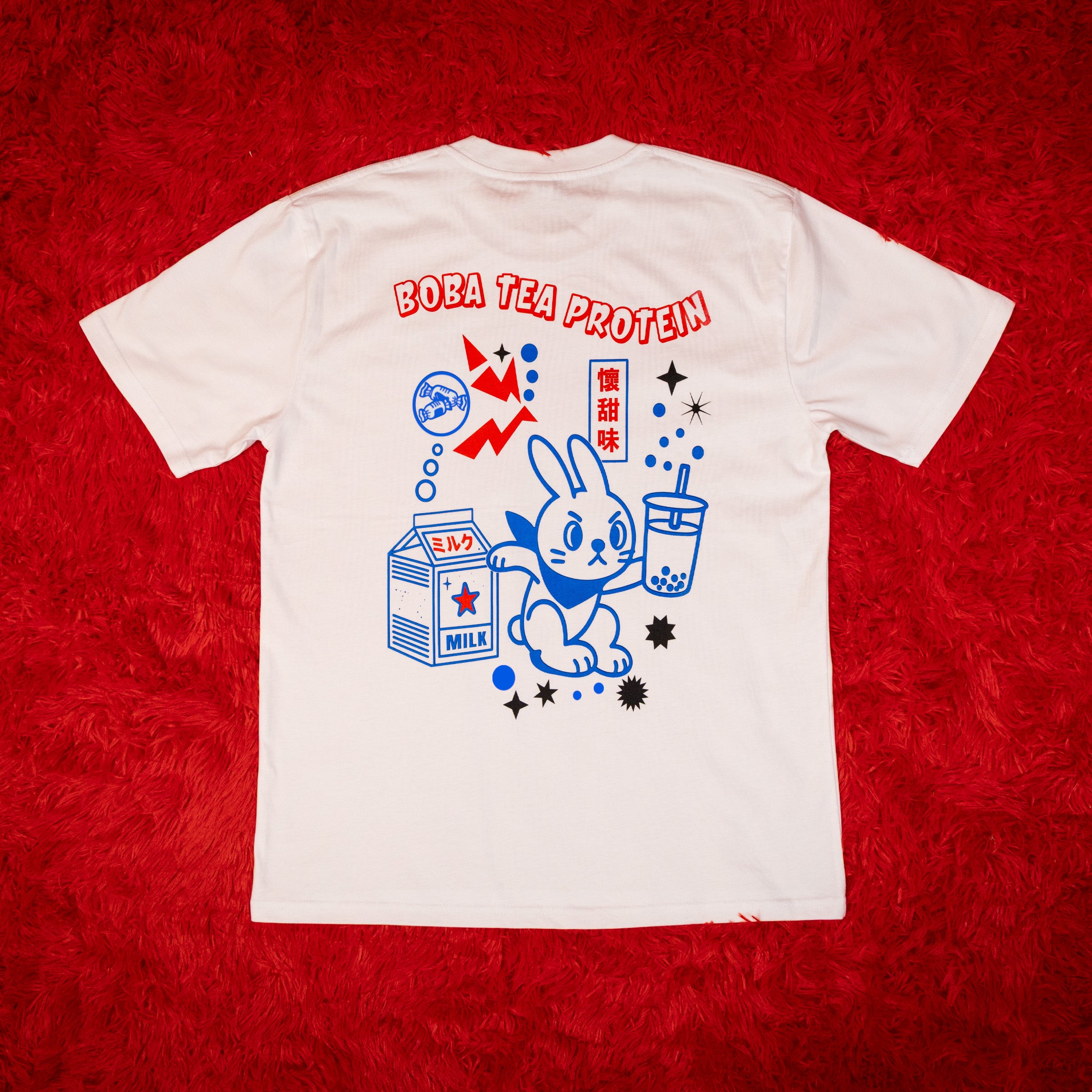 White t-shirt with a rabbit character and text on a red background