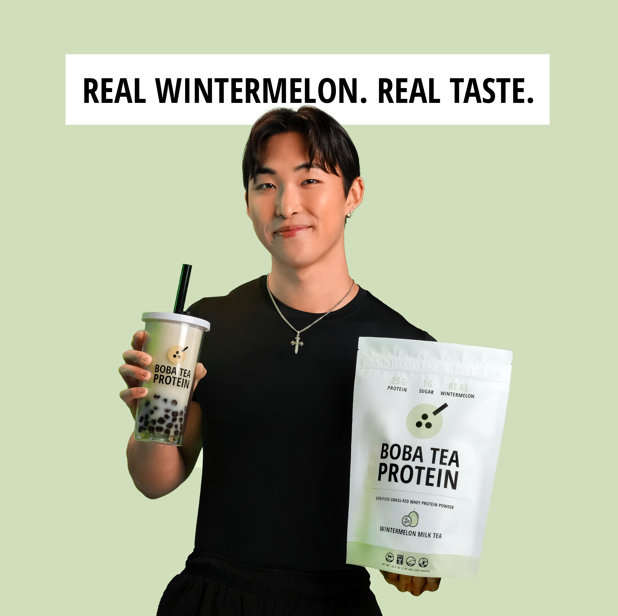 Person holding Boba Tea Protein packaging and a cup against a green background with text.