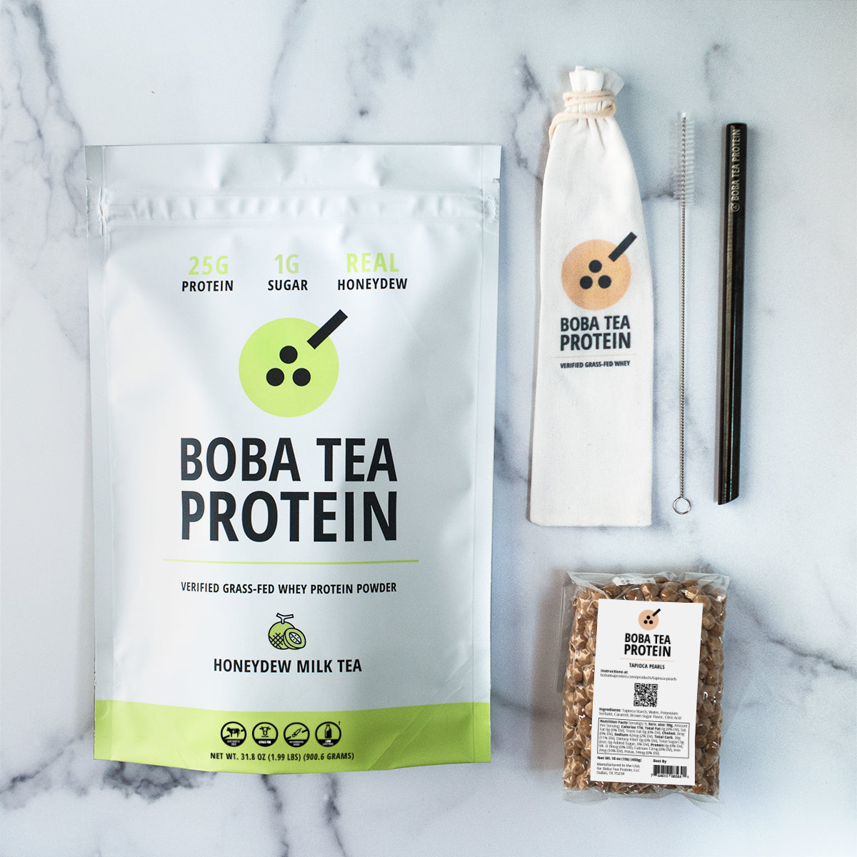 Boba Tea Protein whey protein, metal straw, and tapioca pearls on a marble background