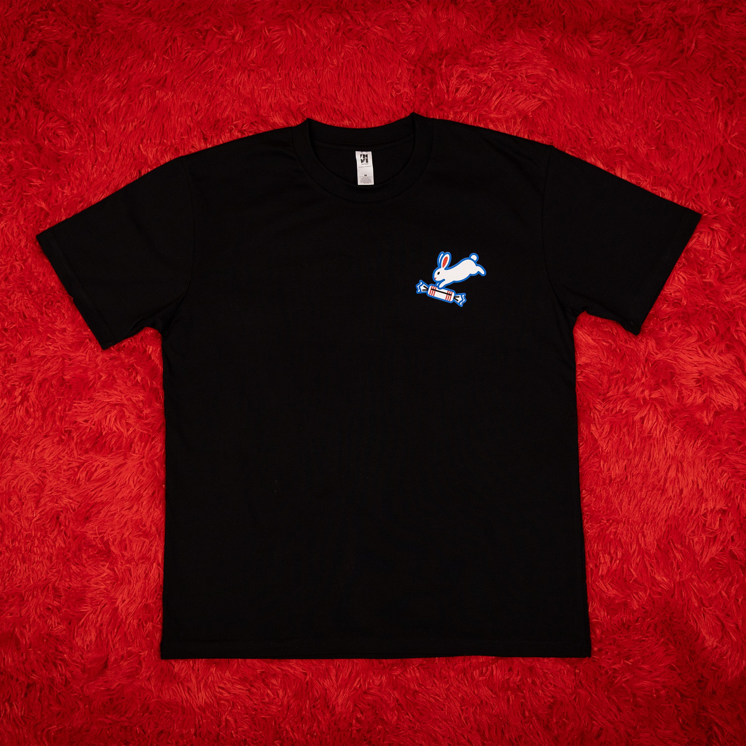 Black t-shirt with a logo on a red textured background