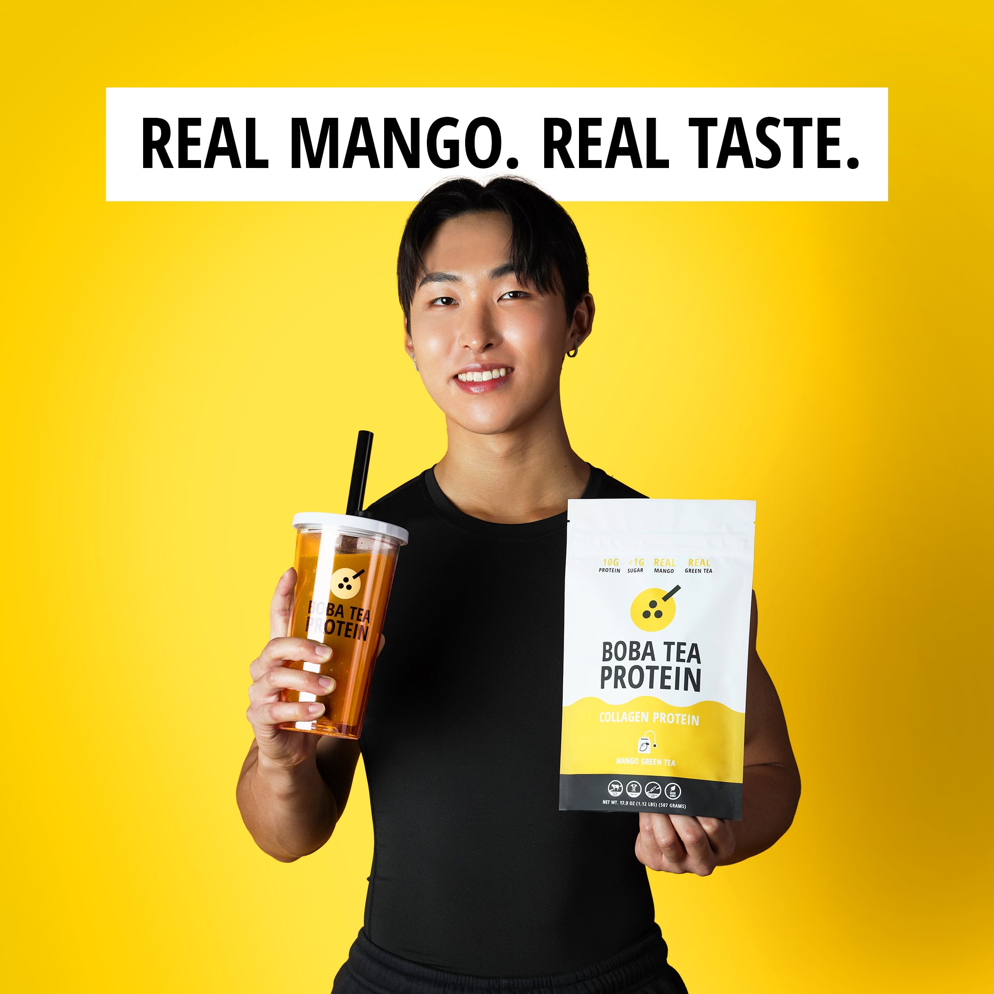 Person holding a Boba Tea Protein package and a drink against a yellow background with 'Real Mango. Real Taste.' text.