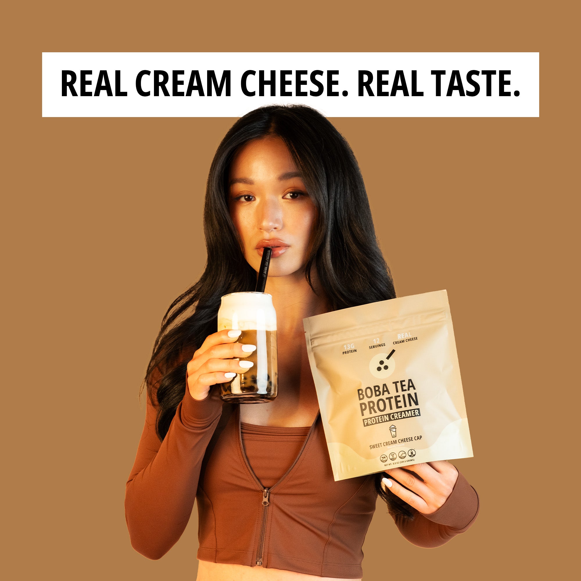 Woman holding a Boba Tea Protein package and a drink with text 'Real Cream Cheese. Real Taste.'