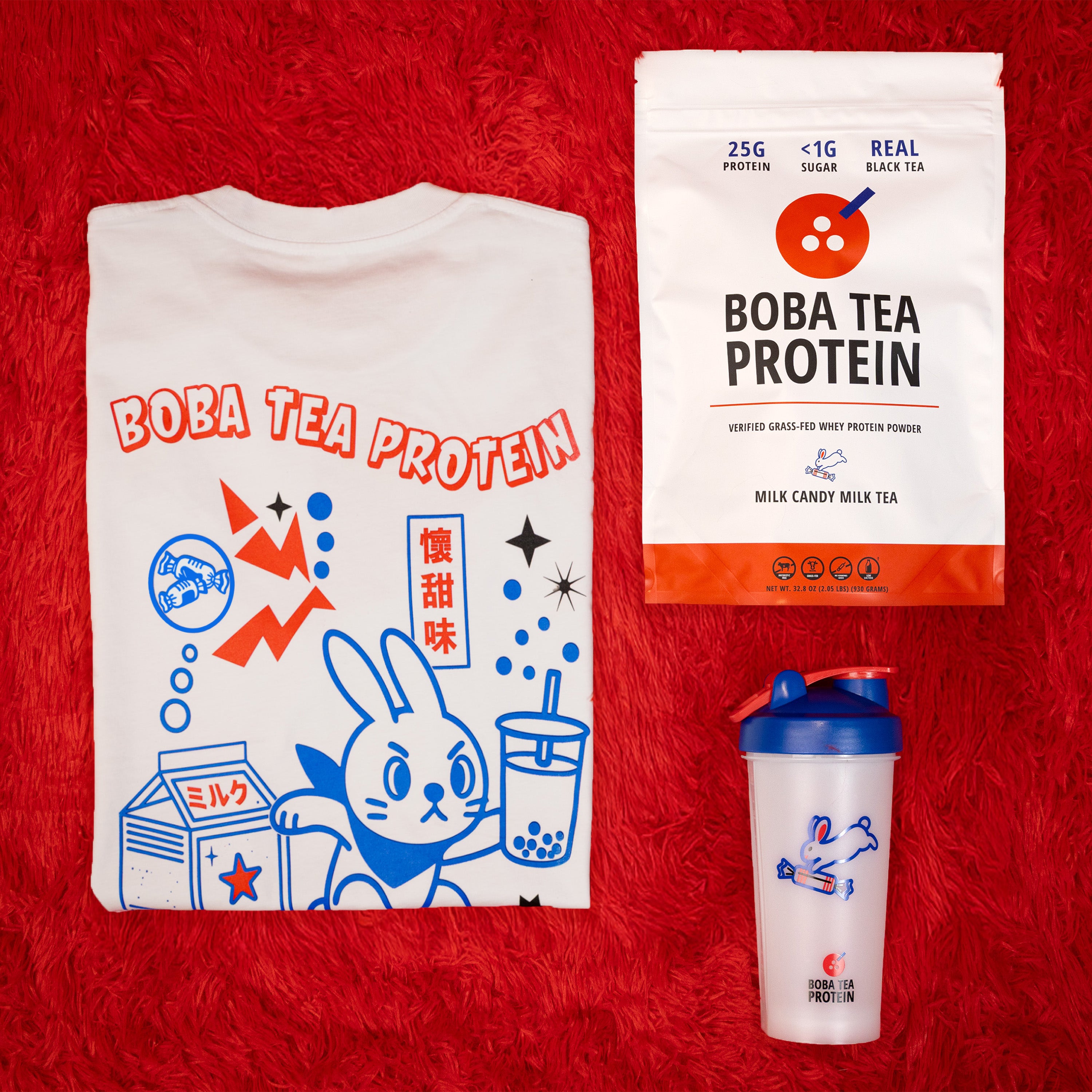 T-shirt, protein powder package, and shaker bottle with Boba Tea Protein branding on a red background